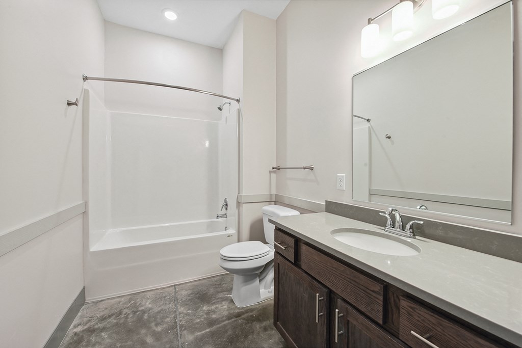 a bathroom with a shower toilet and sink and a mirror