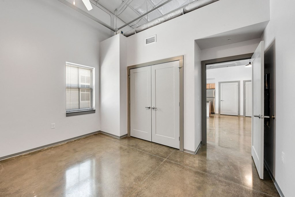 an empty room with white walls and a door to a hallway