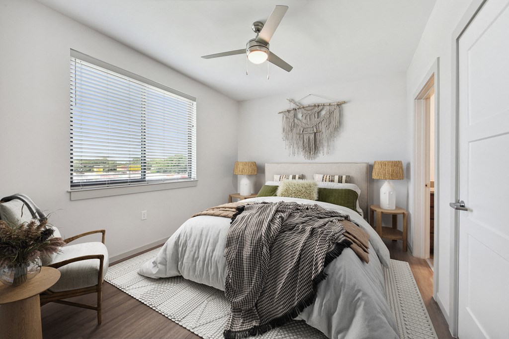 a bedroom with a large bed and a ceiling fan