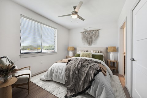a bedroom with a large bed and a ceiling fan