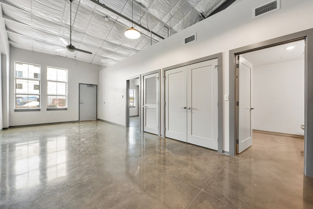 the interior of an empty room with white walls and doors