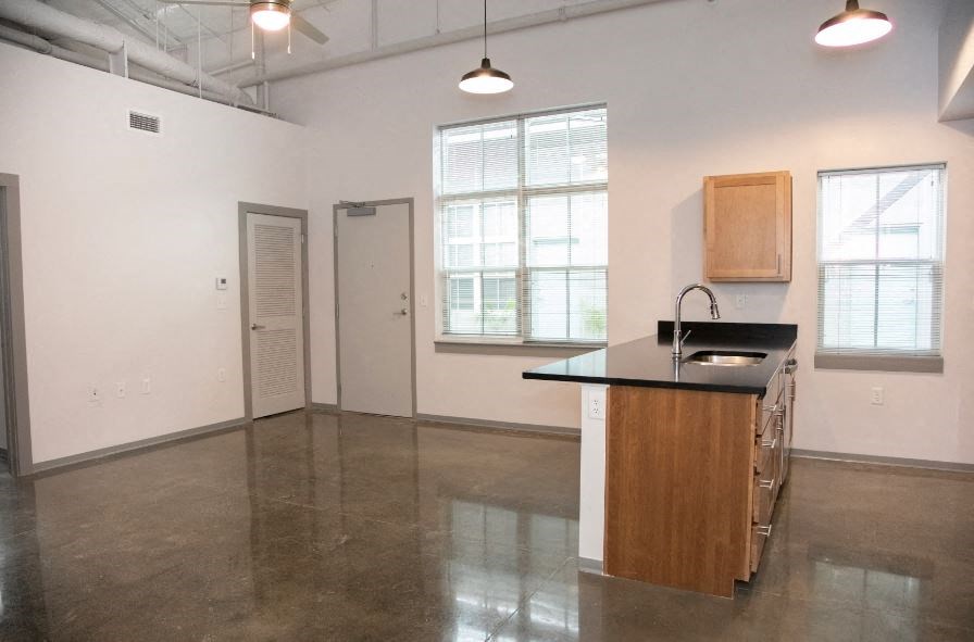 an empty room with an island in the middle of it