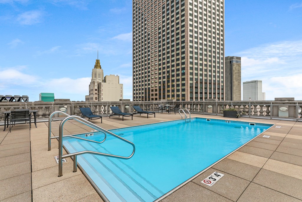 A swimming pool with a metal ladder and a no-swimming sign.