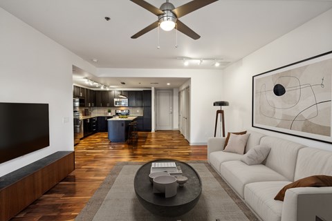A modern living room with a white sofa and a black coffee table.