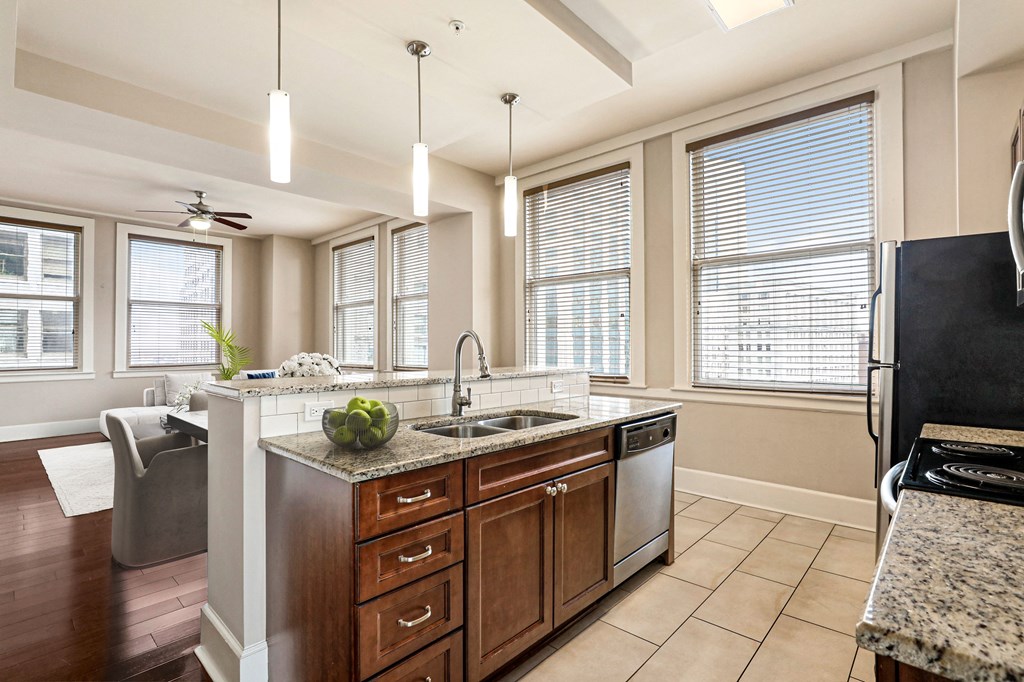 a large kitchen with a sink and a counter top