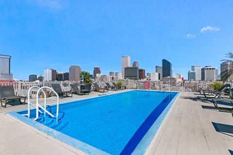 a swimming pool with a city skyline in the background