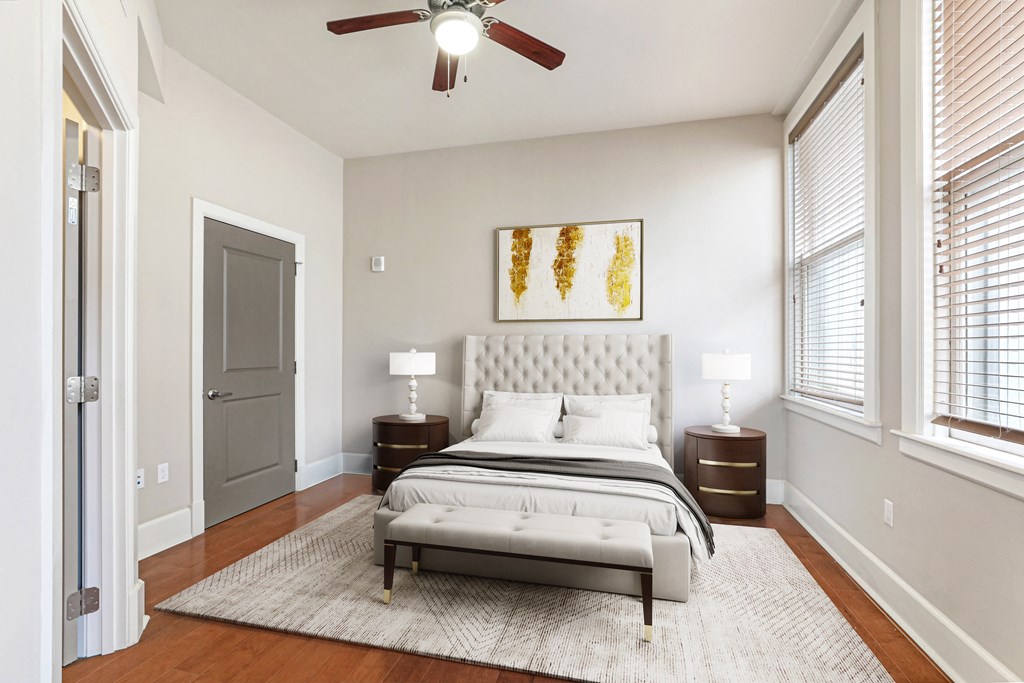 a bedroom with a bed and a ceiling fan