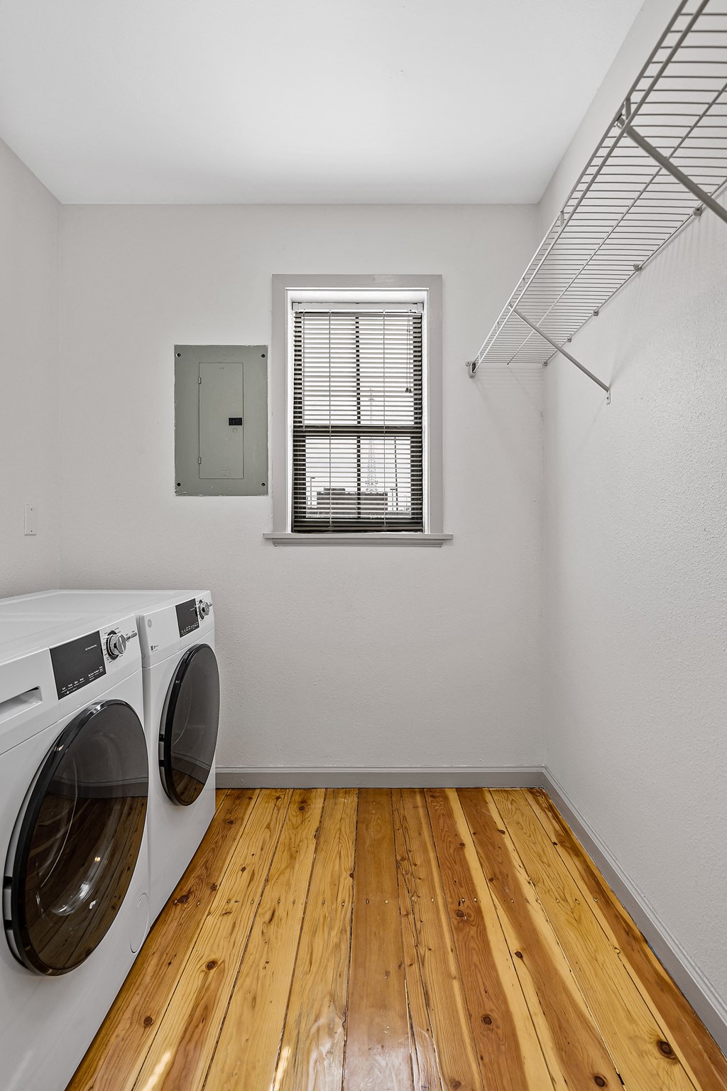 the living room has a washer and dryer in it and a window