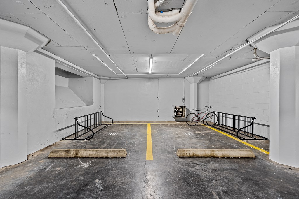 an empty parking garage with a bike parked in the corner