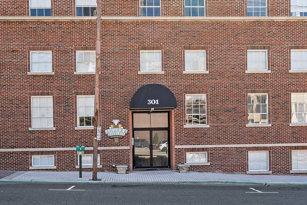 the front of a brick building with a door