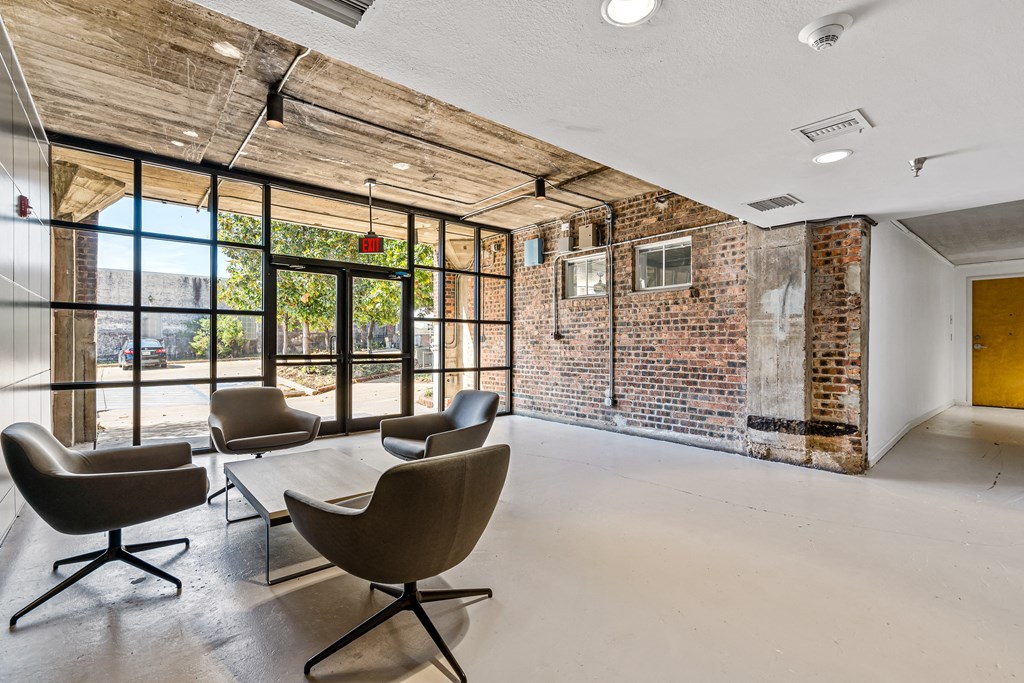 a conference room with chairs and a table and a brick wall