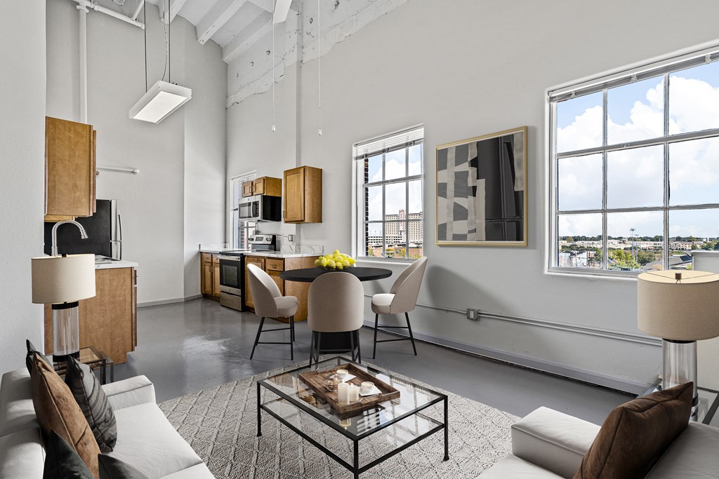 an open living room with a dining room and kitchen in a loft apartment