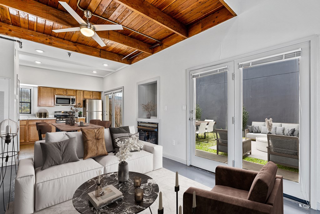 a living room with a couch and a coffee table and sliding glass doors