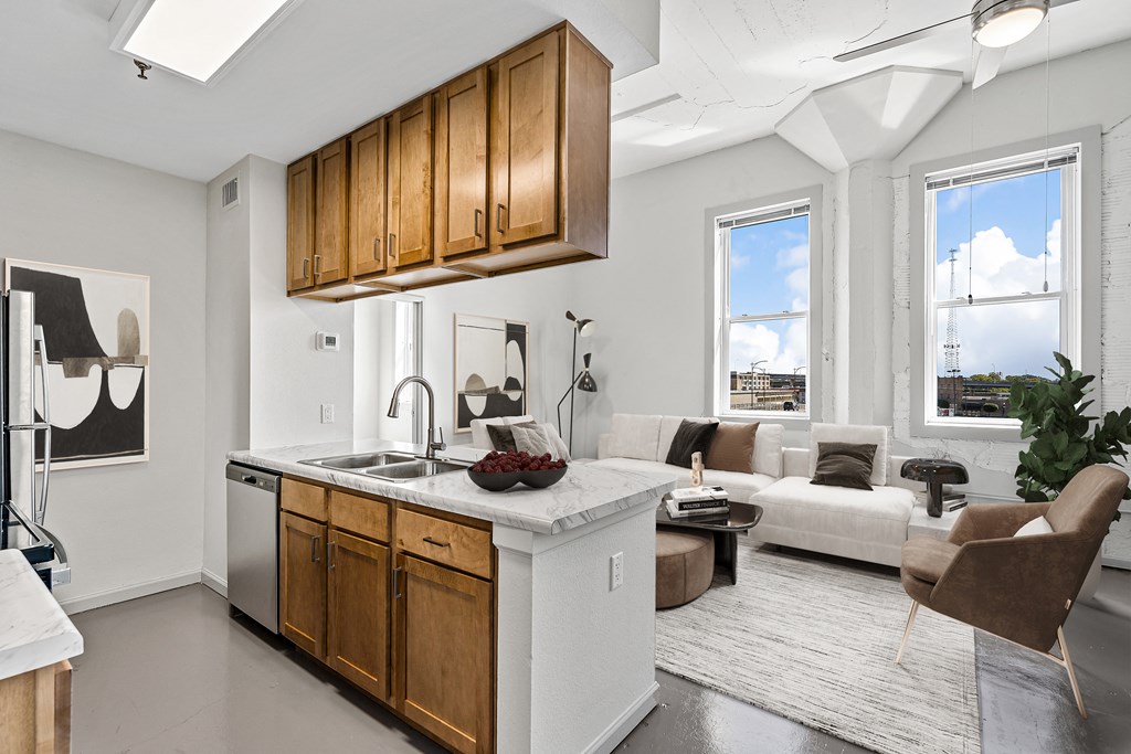 an open kitchen and living room with couches and a table