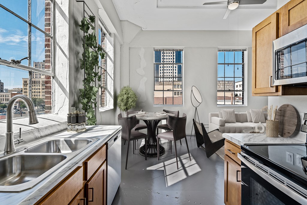 an open kitchen and living room with a view of the city