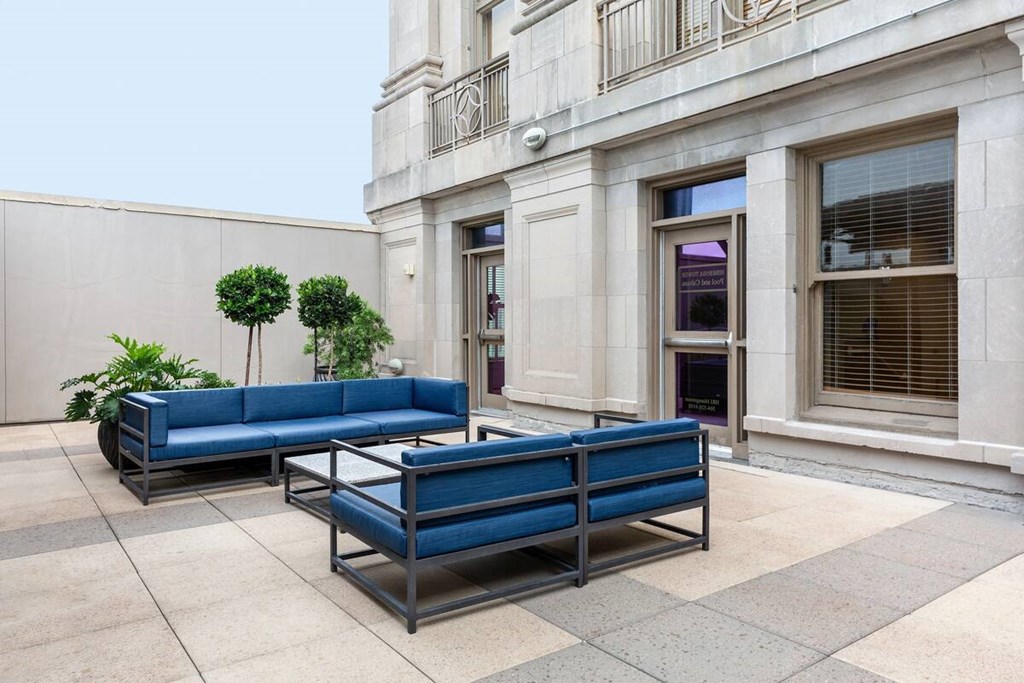 A blue bench is placed in front of a building.