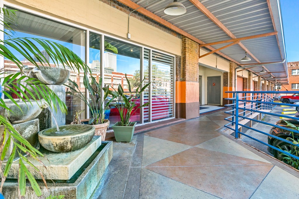 the entrance to a building with plants and a staircase