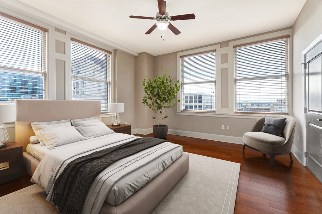 a bedroom with a bed and a ceiling fan