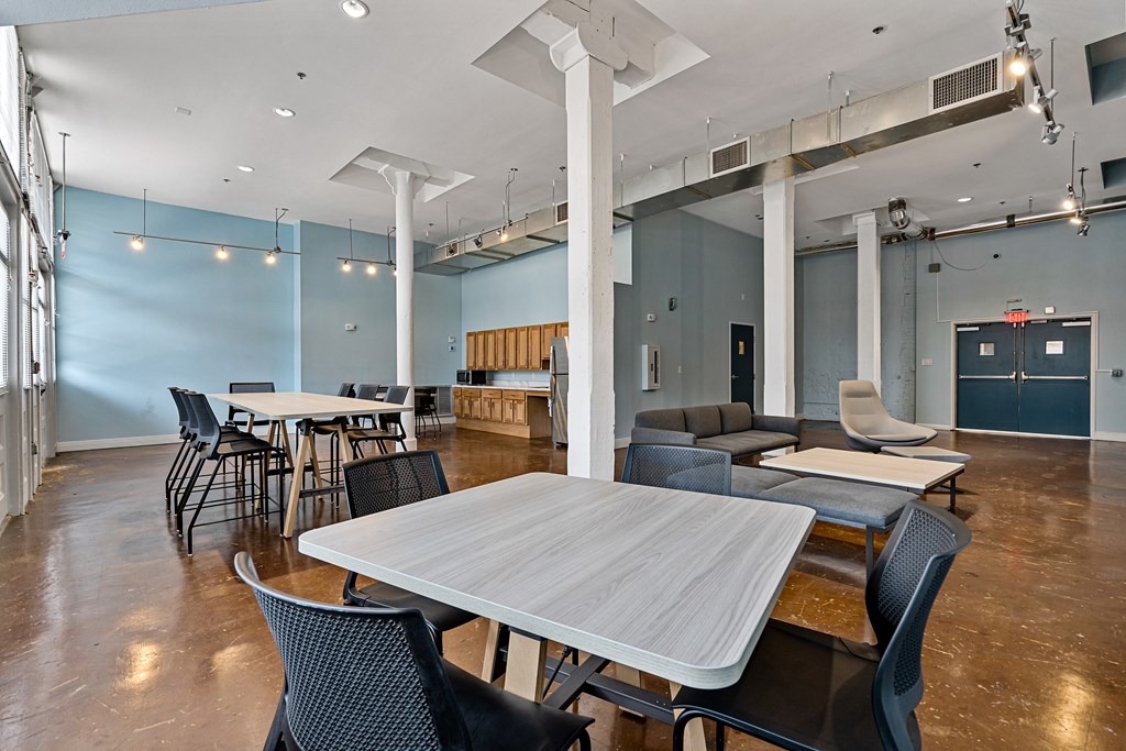 a dining room with tables and chairs and a living room