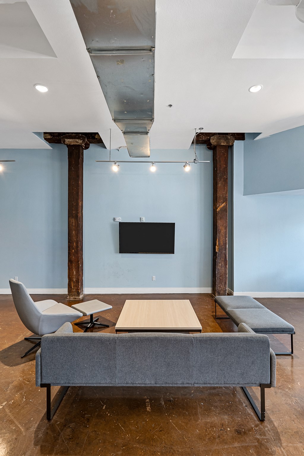a conference room with a table and chairs and a television