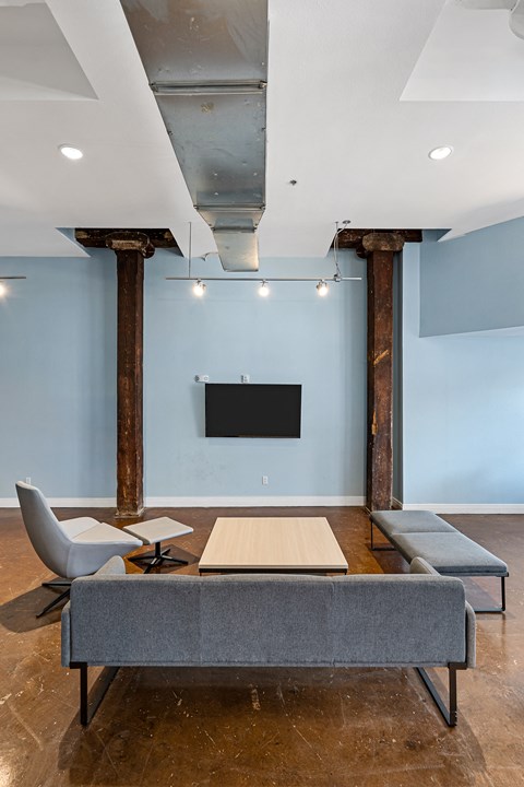 a conference room with a table and chairs and a television