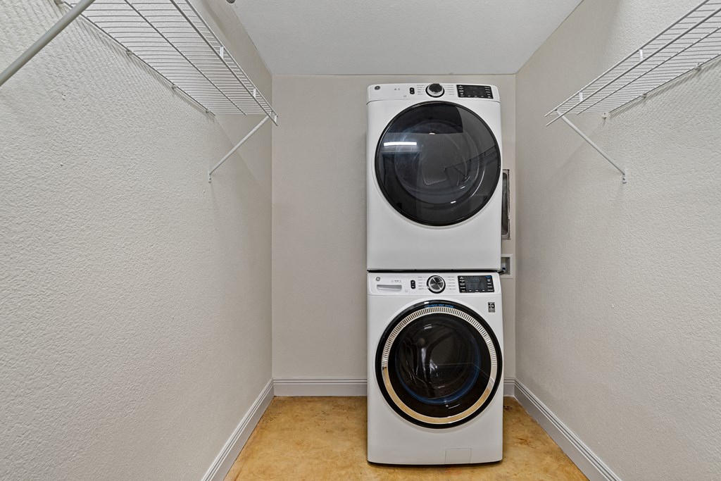 a laundry room with a washing machine and a washer and dryer