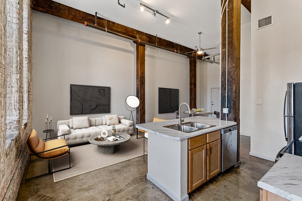 a living room with a kitchen and a couch and a sink