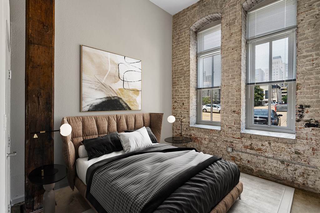a bedroom with a bed and exposed brick walls