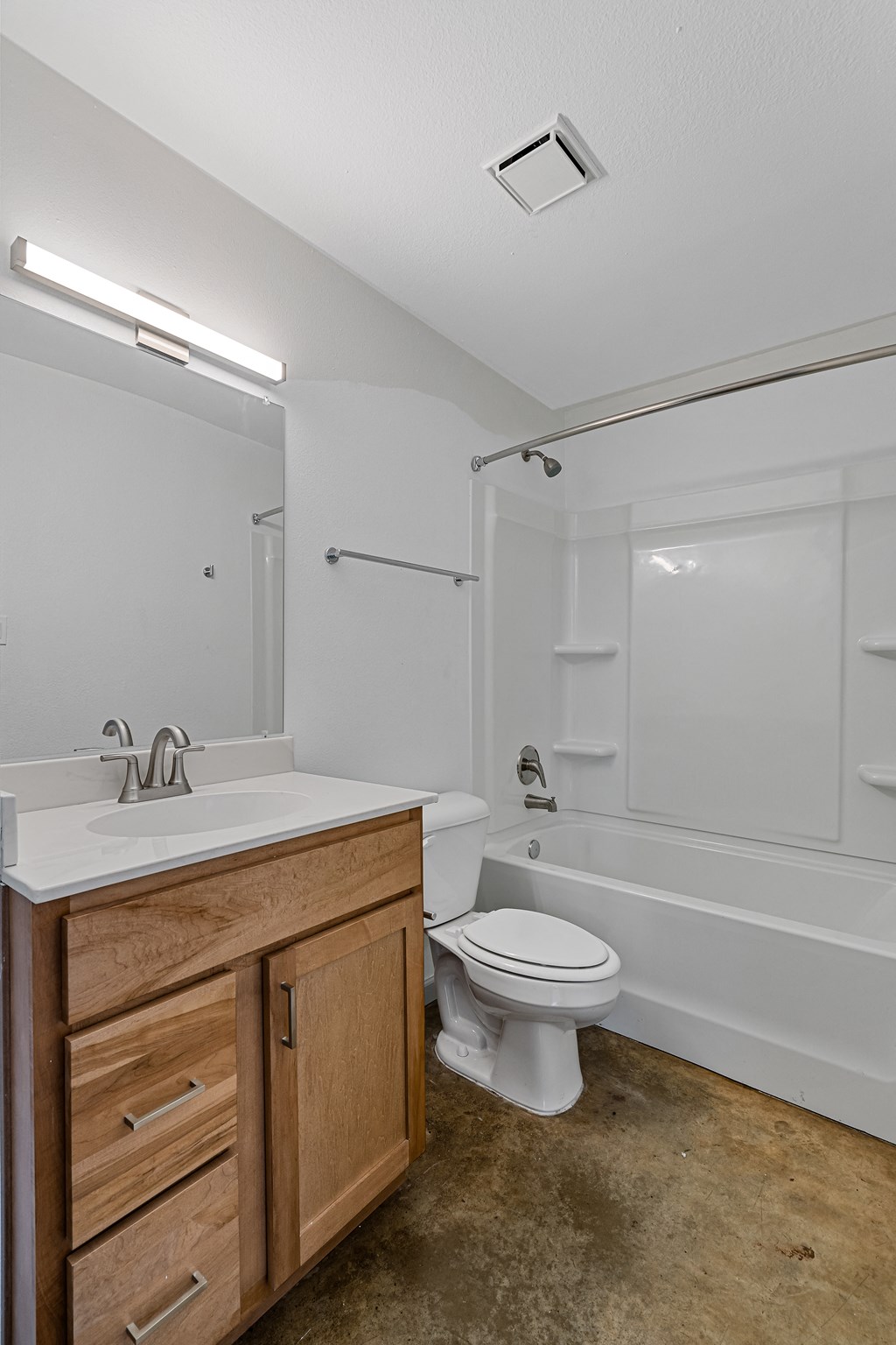 an empty bathroom with a sink toilet and shower