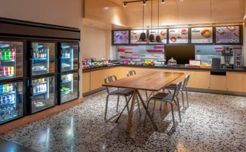 A modern kitchen with a wooden table and chairs.