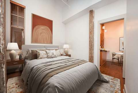 a bedroom with a bed and a door to a bathroom