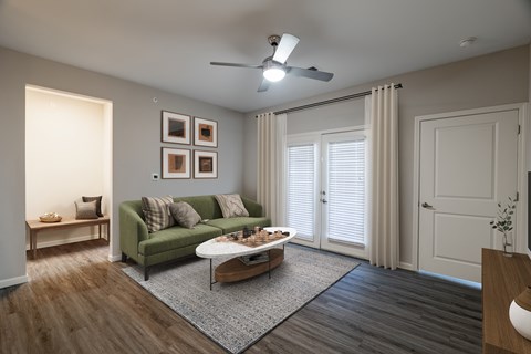 A living room with a green couch and a coffee table.