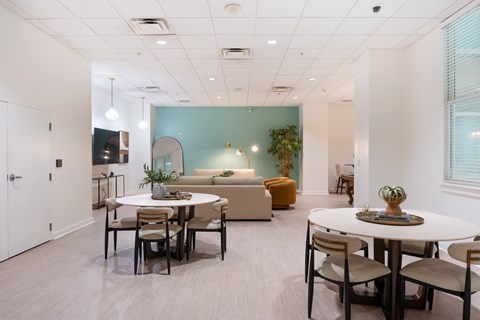 A dining room with a white table and chairs.