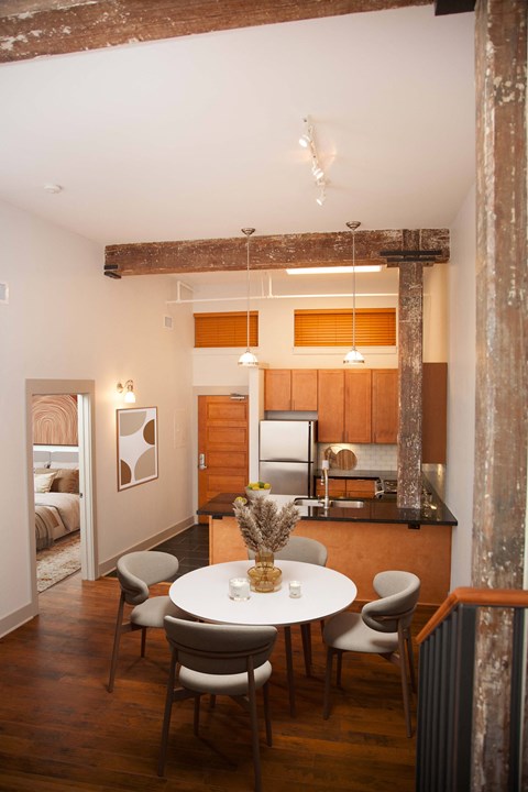 a kitchen and dining area with a white table and chairs