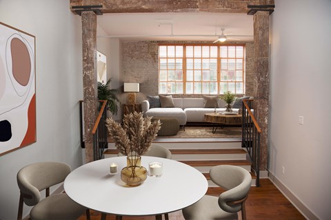 a living room and dining room with a white table and chairs