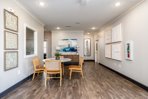 A dining room with a table and chairs.