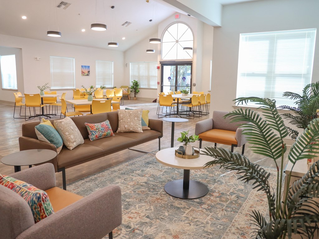 a living room with couches and tables and chairs in a building