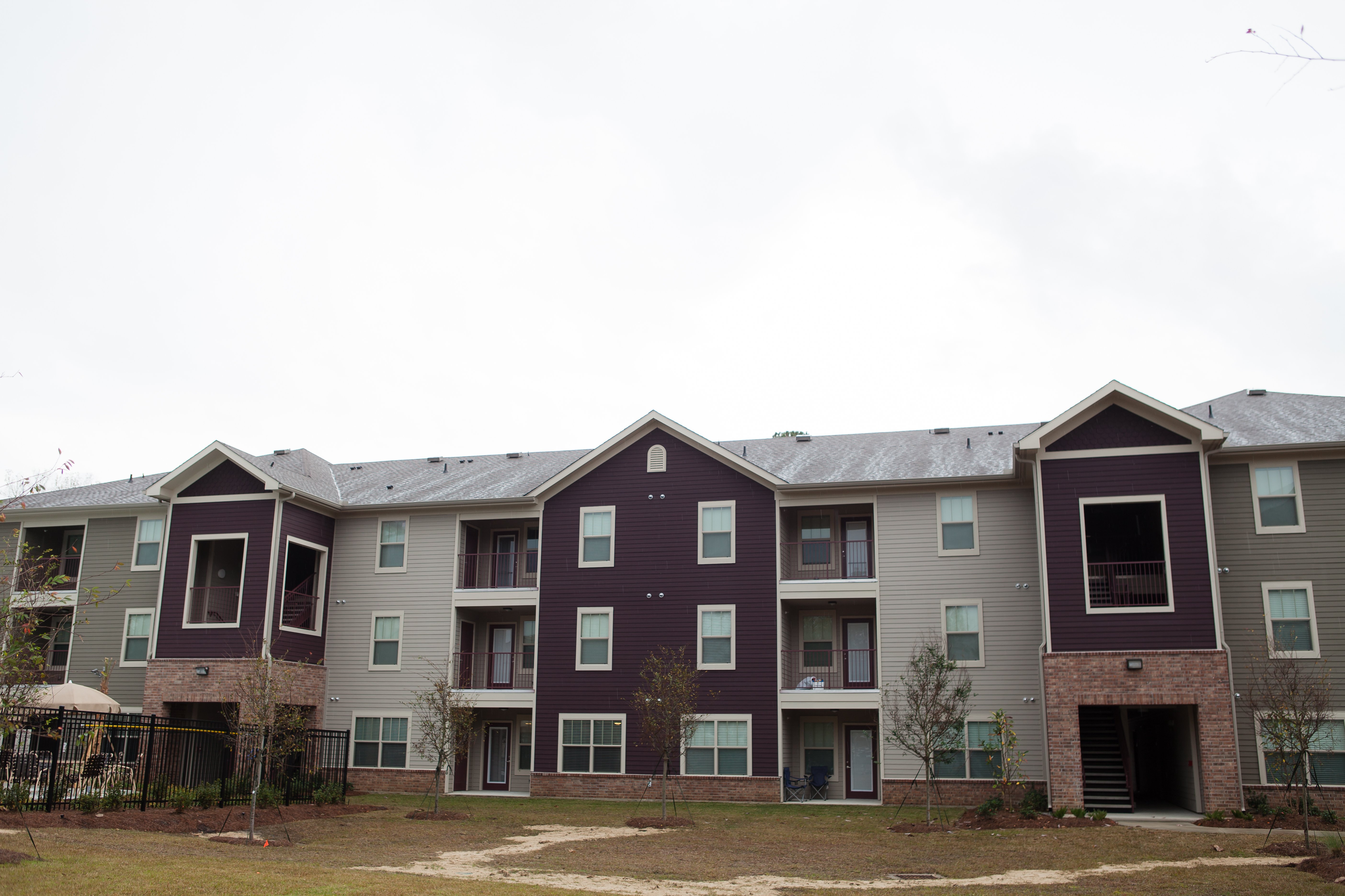 Apartment building with grey and purple exterior.