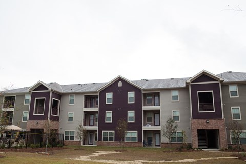 Apartment building with grey and purple exterior.