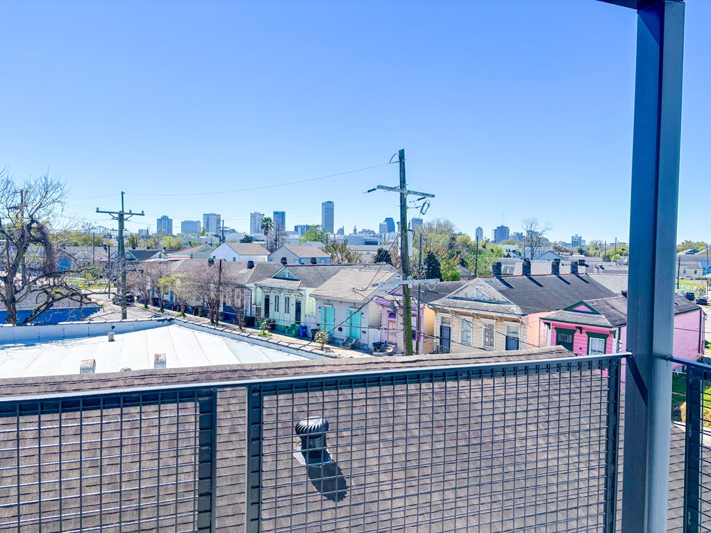 A view of a city skyline from a balcony.