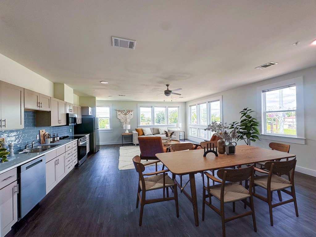 A modern kitchen with a dining table and chairs.