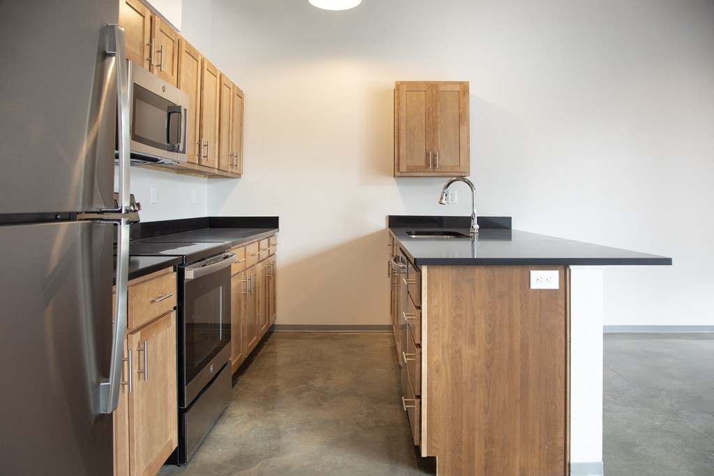 a kitchen with wooden cabinets and stainless steel appliances