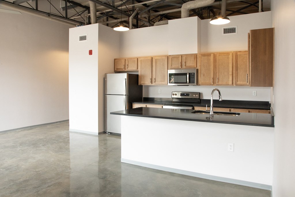a kitchen with a black counter top and a sink