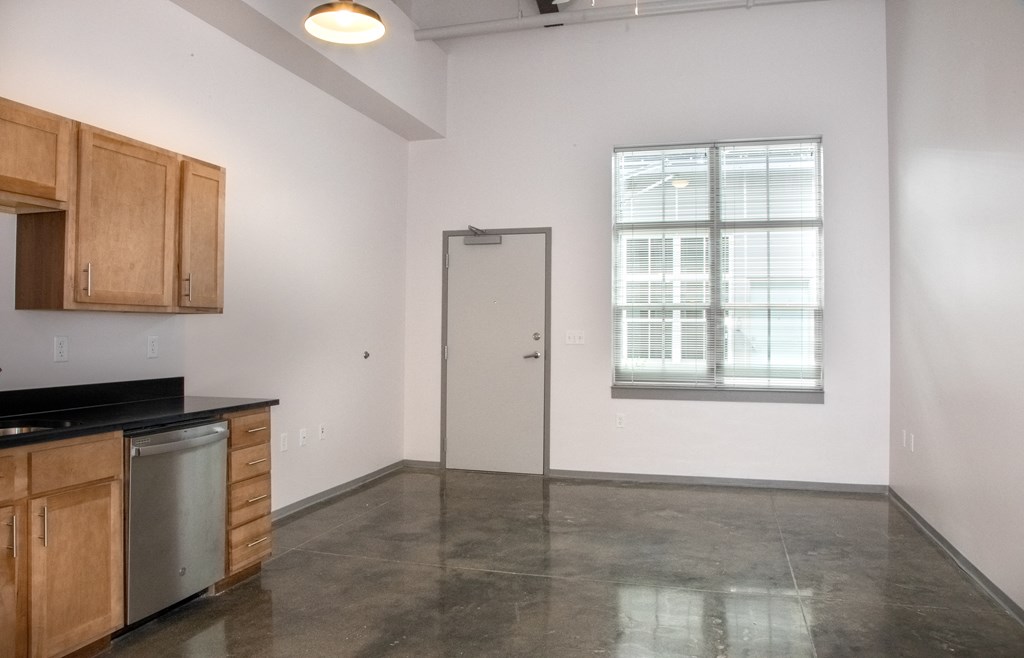 an empty kitchen and living room of an apartment
