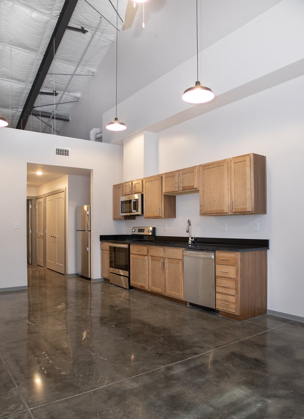 a kitchen with wooden cabinets and stainless steel appliances