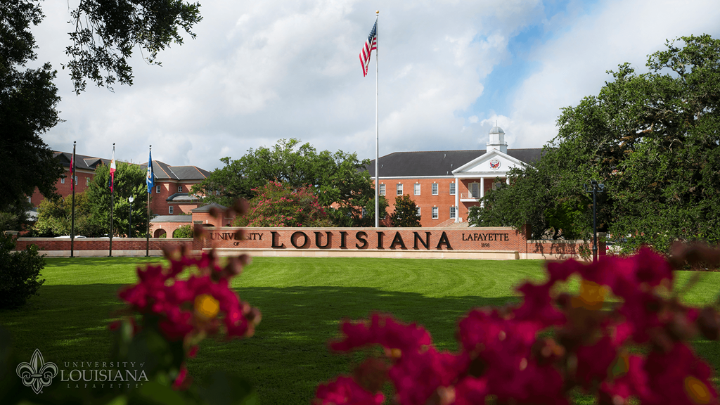 a view of the campus with the flag flying