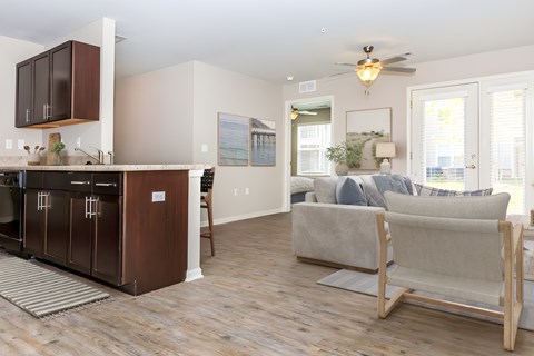 A modern kitchen with dark wood cabinets and a white island.