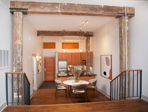 a dining area with a table and chairs in a room with a kitchen