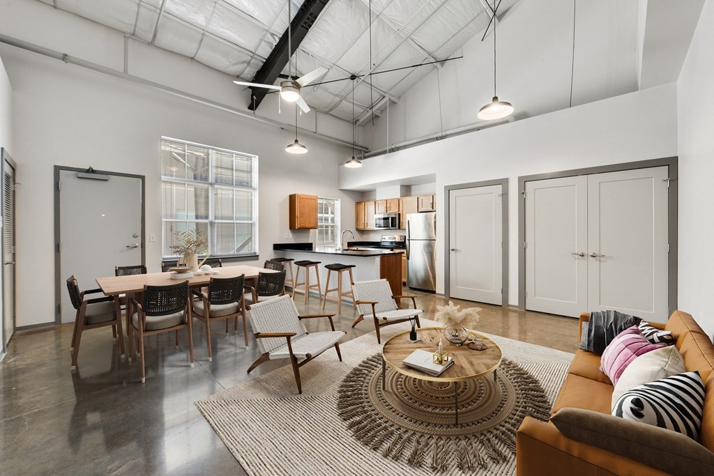an open living room and kitchen with a table and chairs
