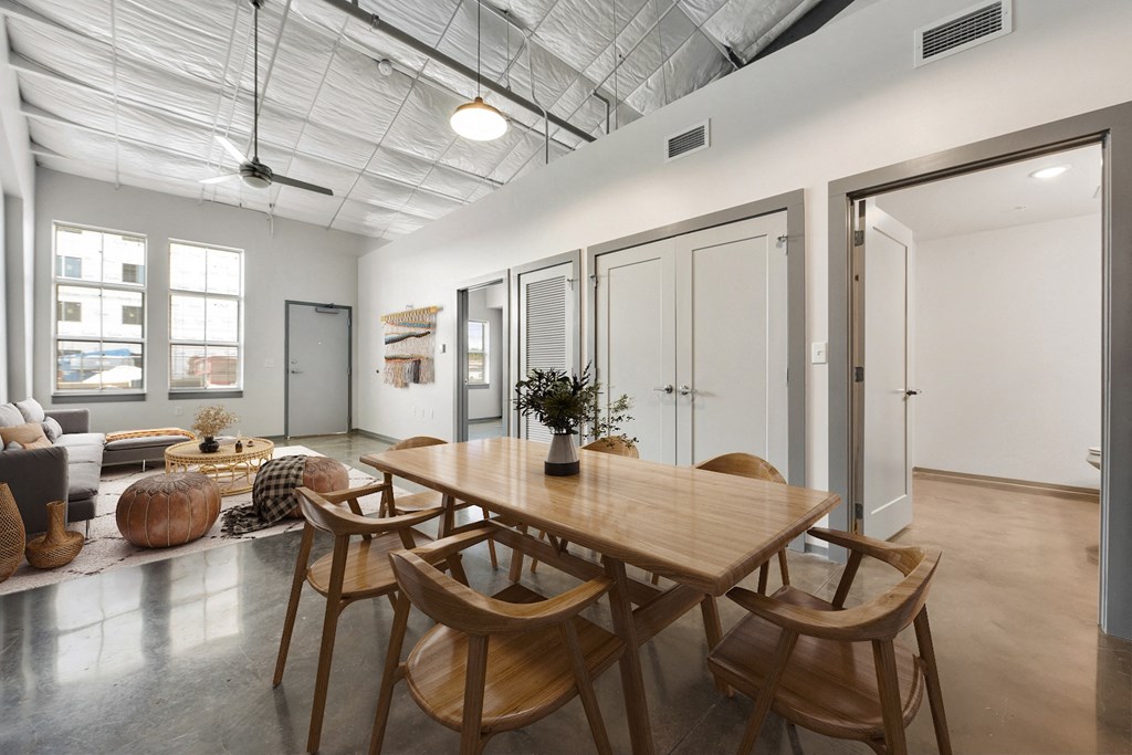 a dining room with a wooden table and chairs